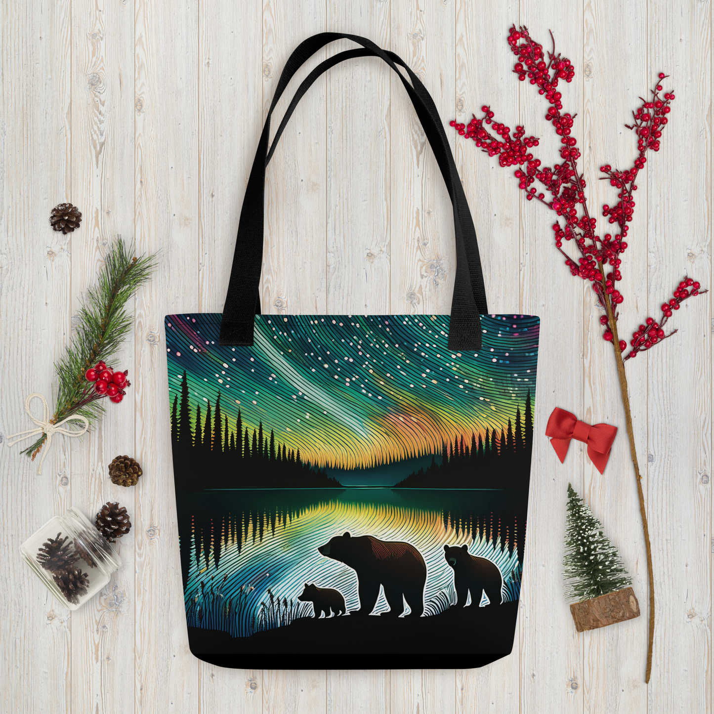 Tote bag with bear design and northern lights on a wooden surface