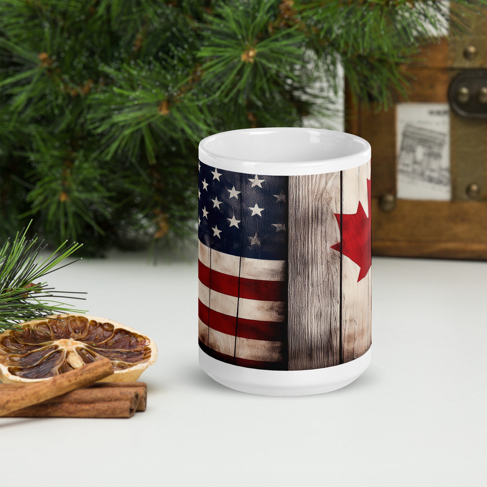 Mug with American flag design on a wooden surface with Christmas decorations.